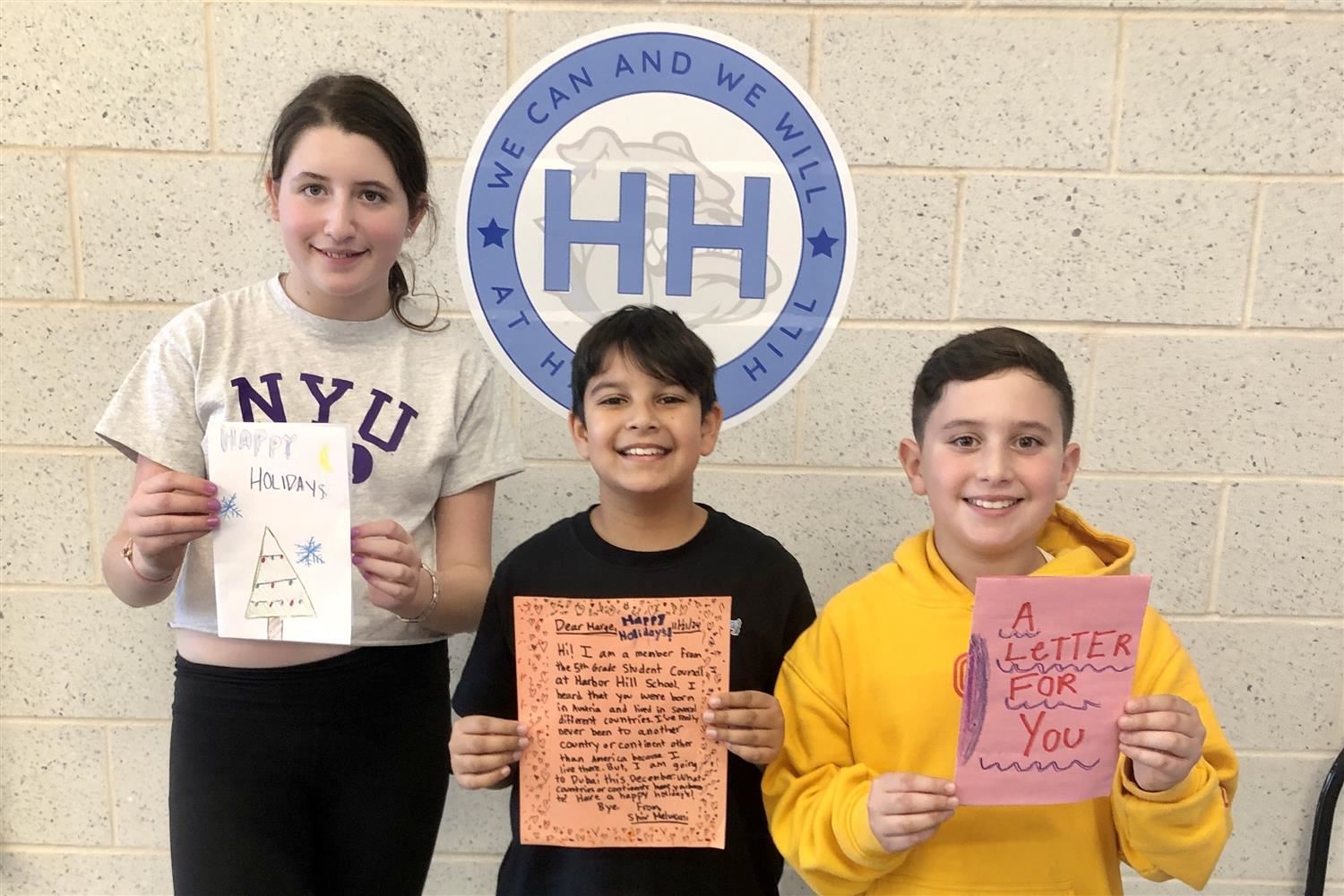  students holding letters